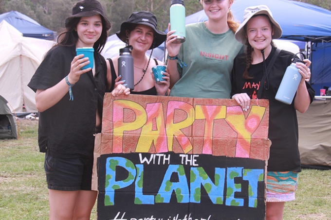 People holding a large Party with the Planet sign