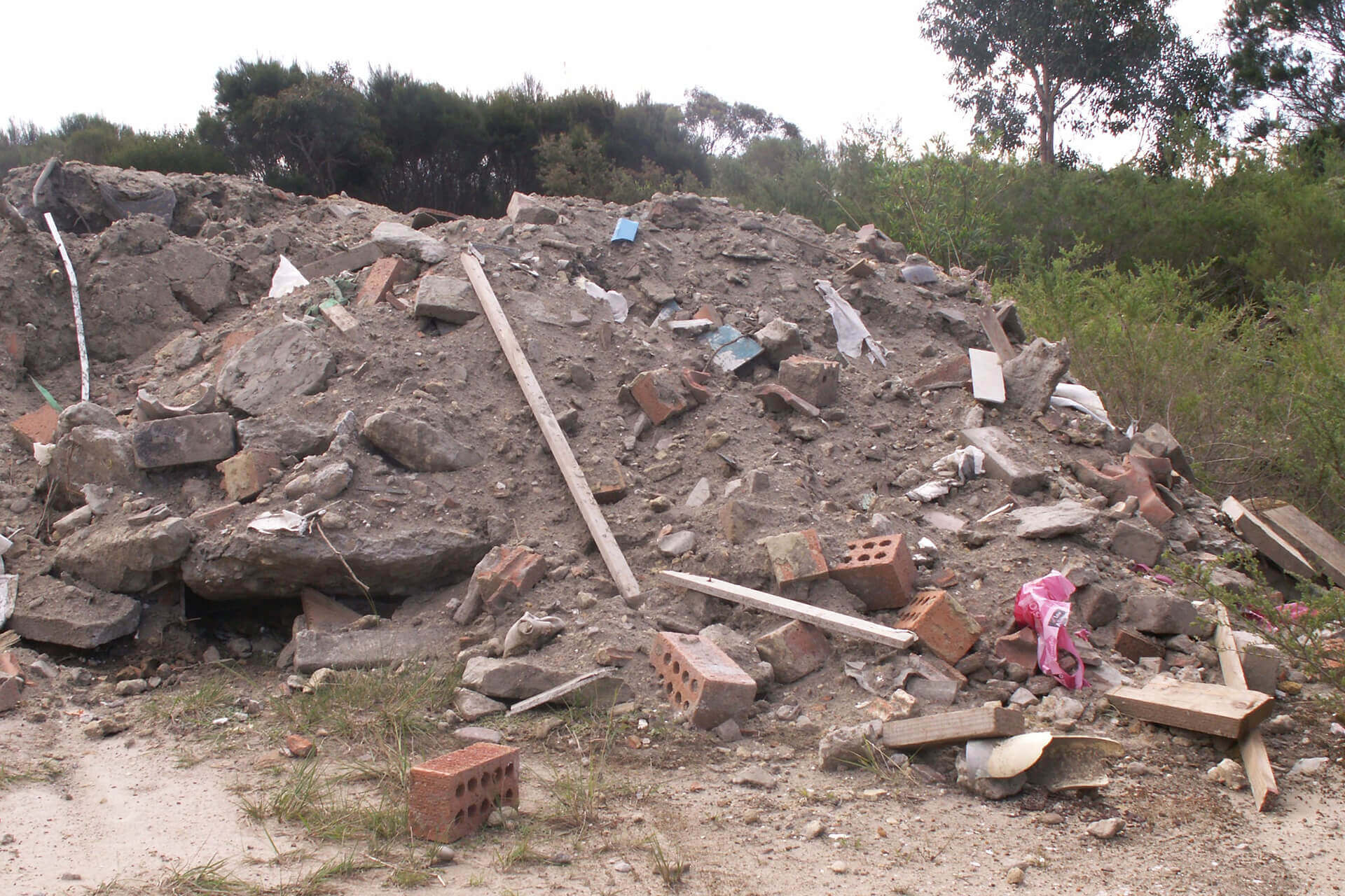 Illegally dumped pile of construction waste and soil