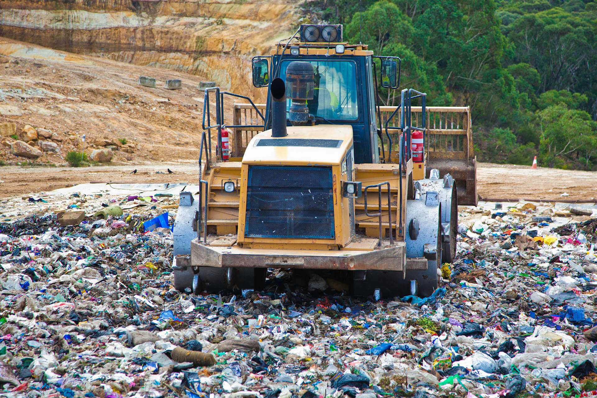 Compactor machine on landfill