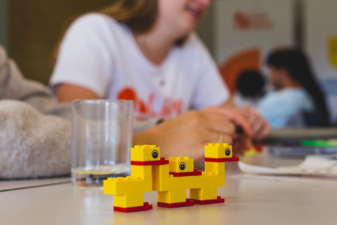 Legos on a table with a person in the forground