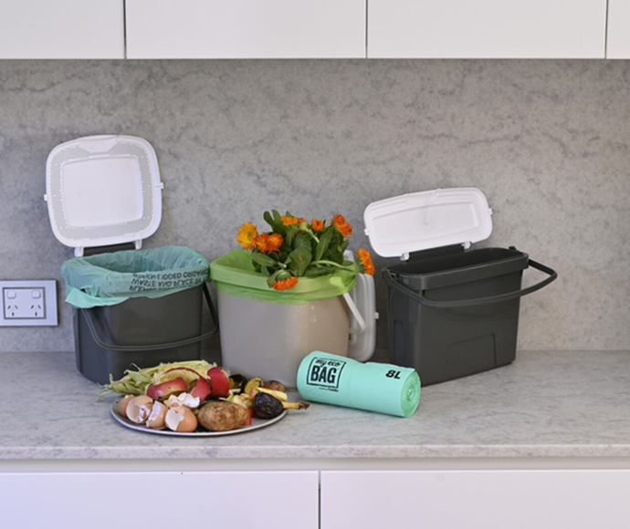 mini fogo bins on kitchen benchtop with plate of food scraps and dead flowers