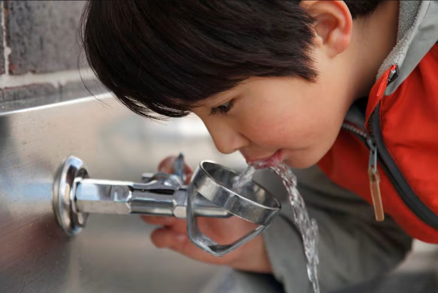 Child drinking out of a water bubbler