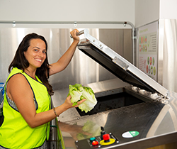 Paramount Hotel, woman adding organics to recycling bin