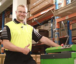 worker with a paper compressing machine