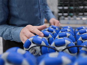 man's hand inspecting plastic moulded wheels